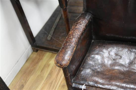 An 18th century boarded oak framed armchair,